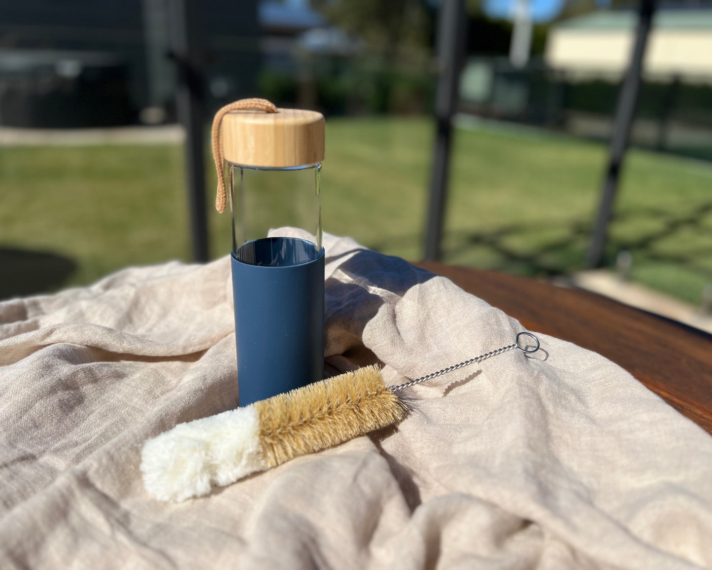 Glass water bottle with bottle brush